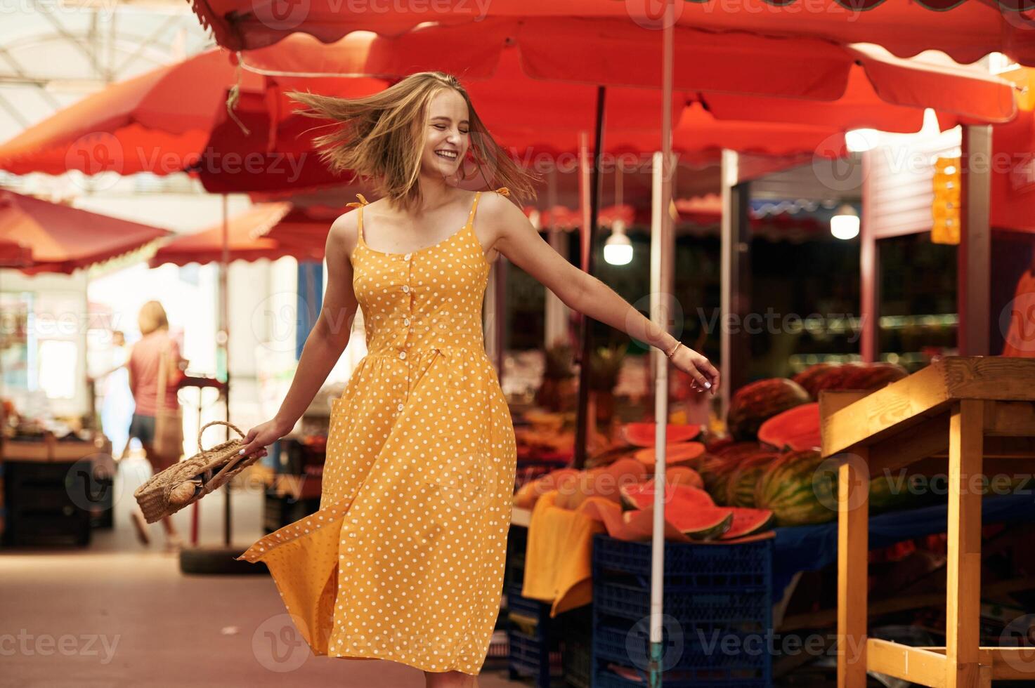 Photo, in, motion, dancing, smiling. Young woman is on the vegetable market or bazaar photo