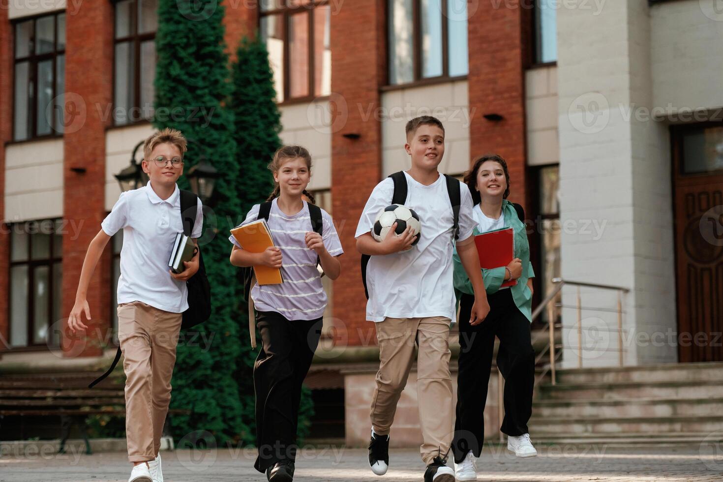 Group ,of kids ,are near the school together, pupils photo