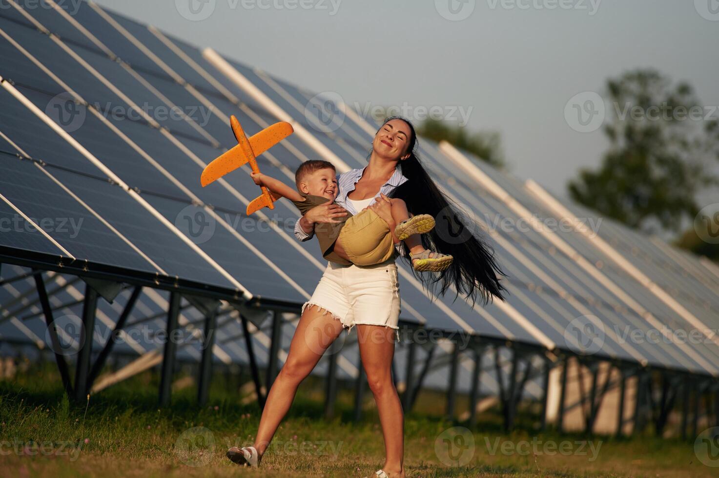 Mother with her little son are nea,r the ,solar ,panels photo