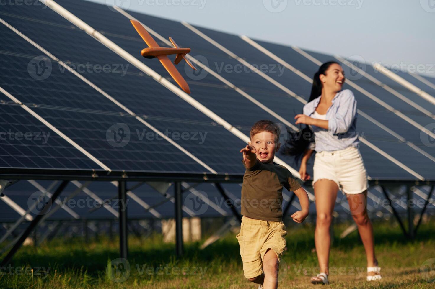 Mother with her little son are near the solar, panels photo