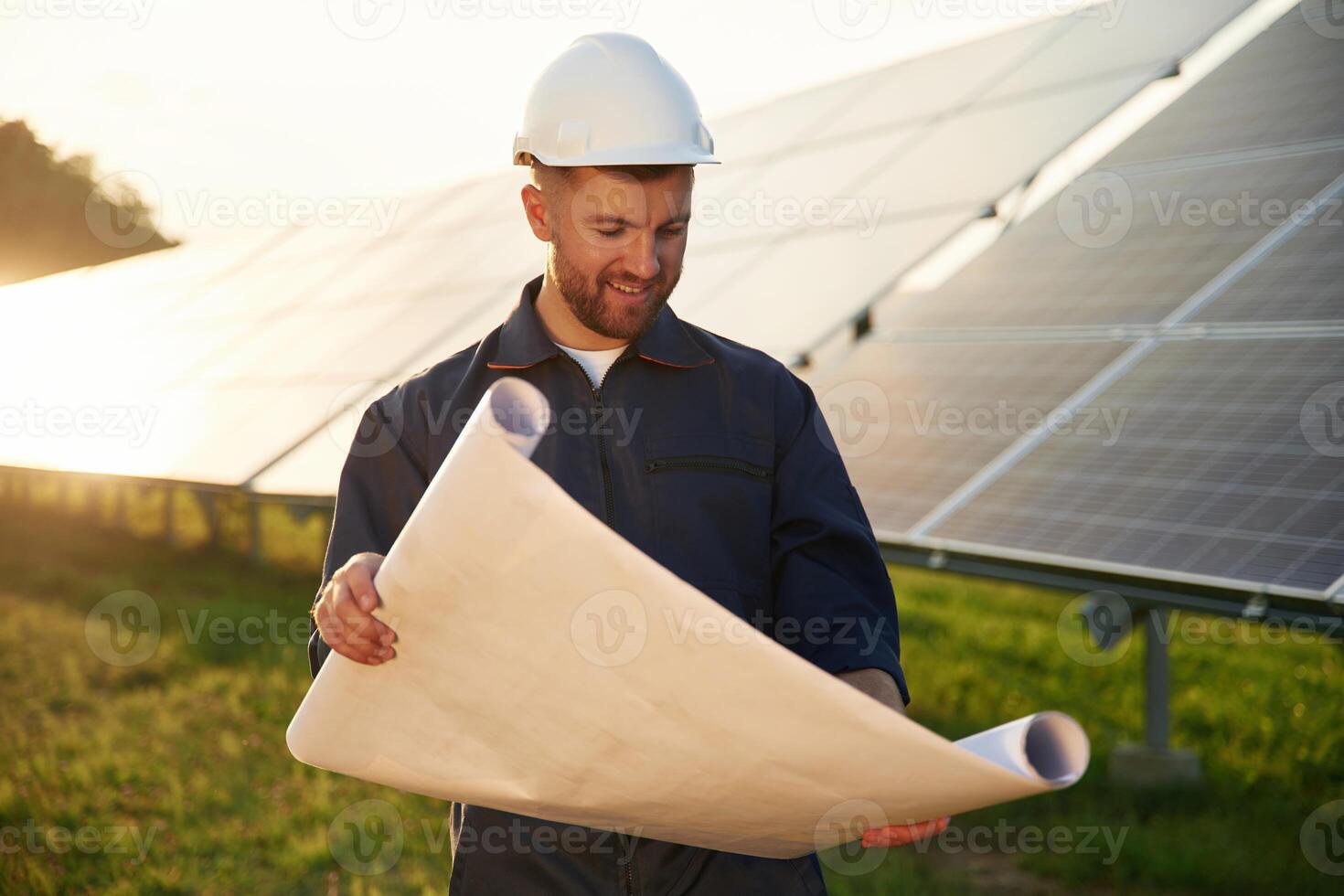 Pape,r plan, in, hands. Man is working with solar panels outdoors at daytime photo