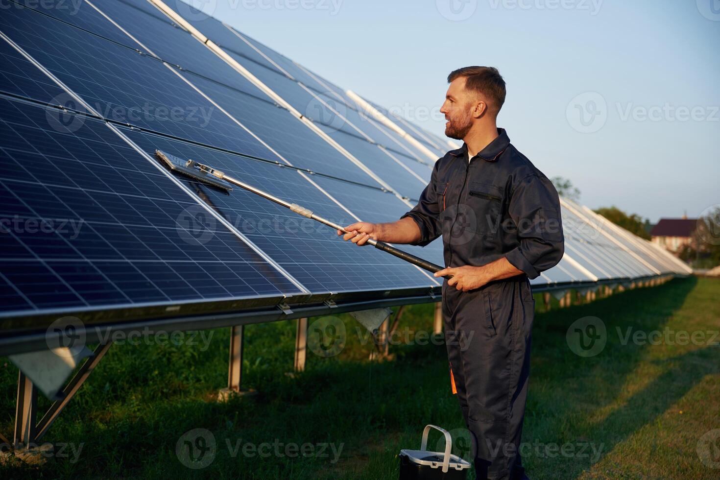 Keep it, clean., Man is working with solar panels outdoors at daytime photo