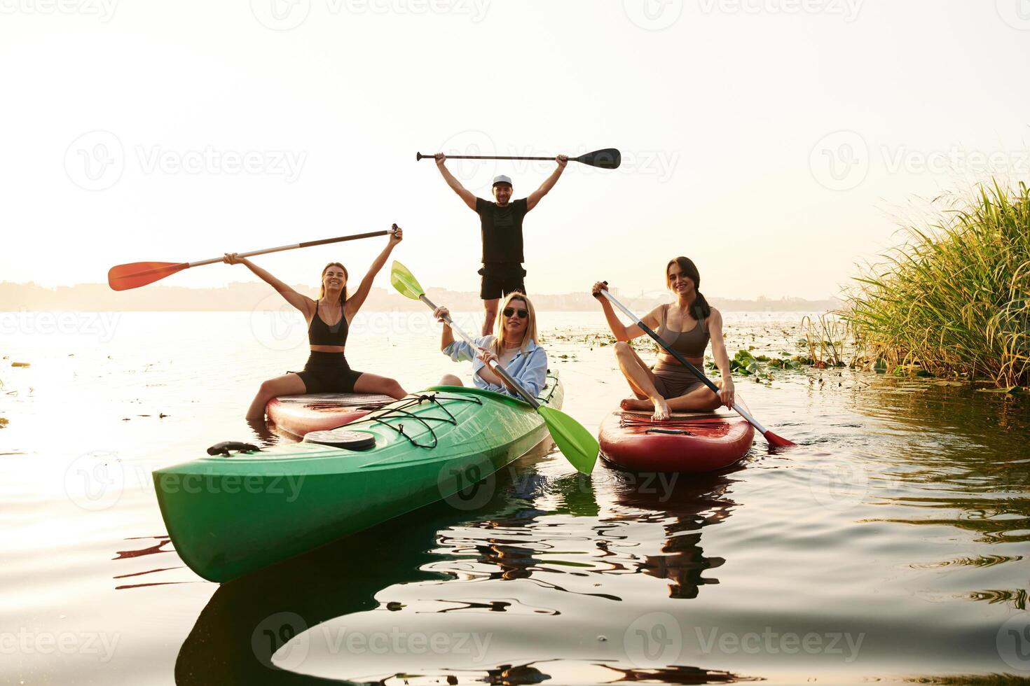 Women and man... Friends are together on sup boards on the lake photo