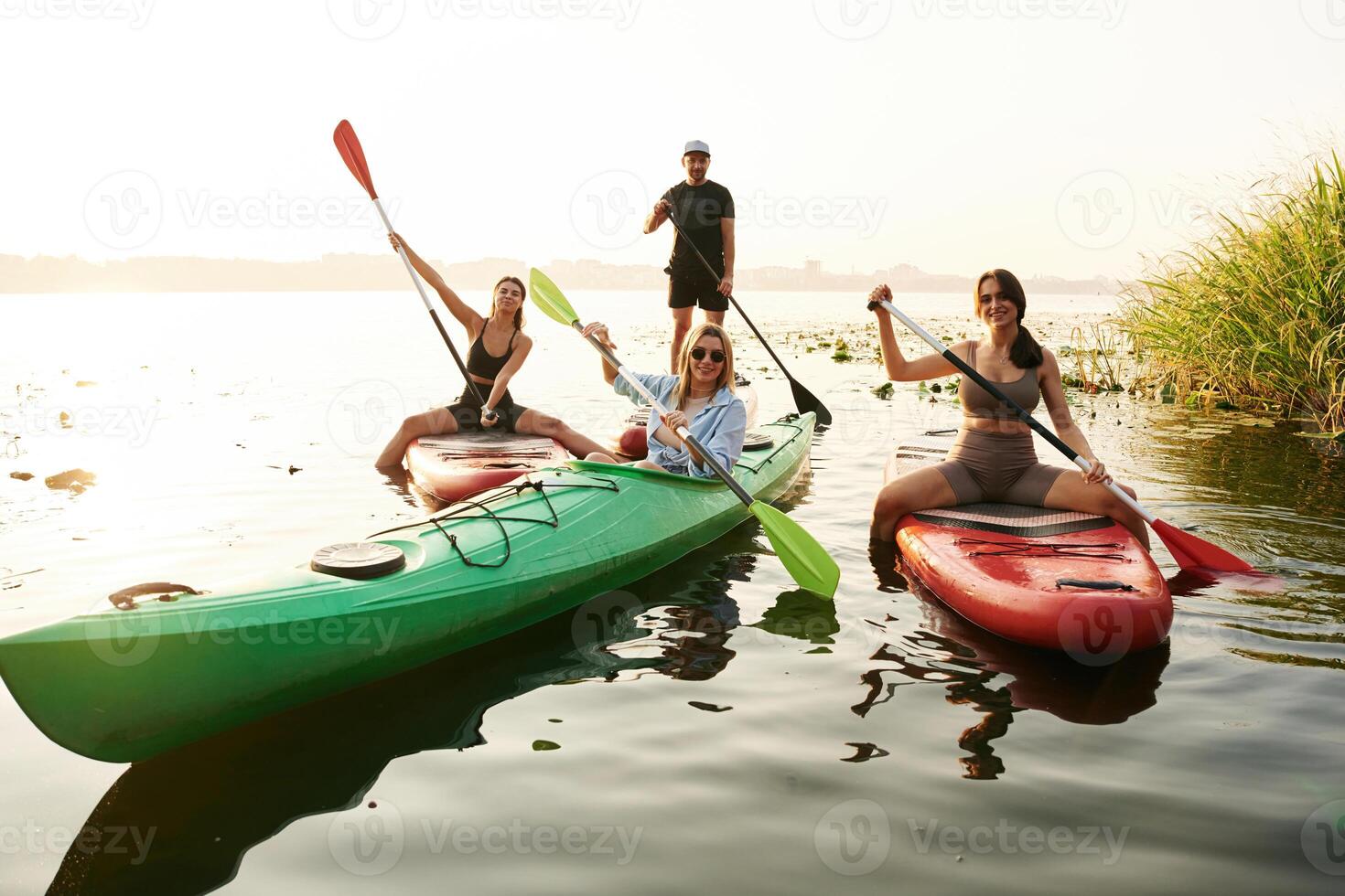 Wome,n and ,man. Friends are together on sup boards on the lake photo