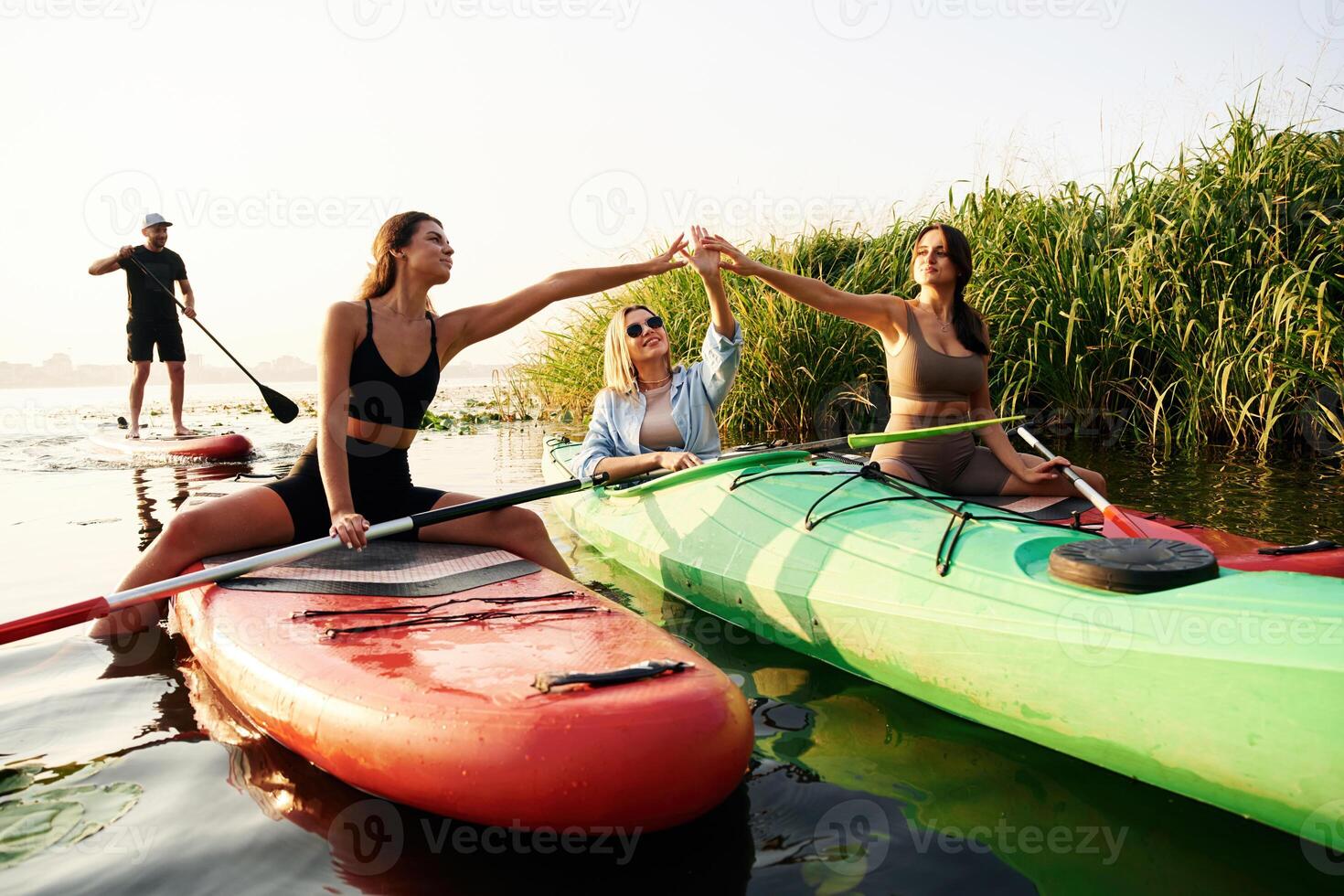 On, the lake. Friends are together ,,on ,sup boards photo