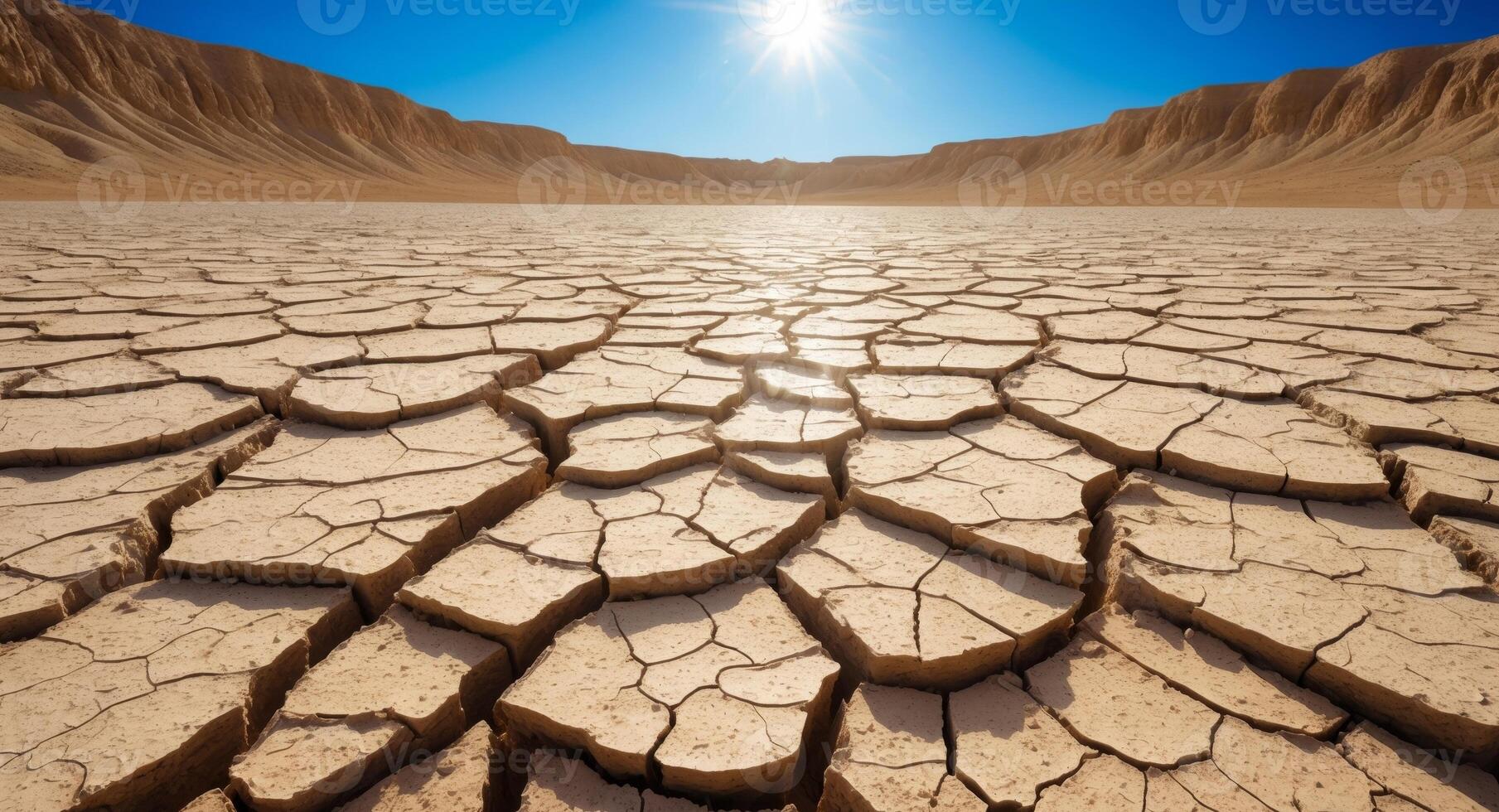 Arid Landscape. Cracked Earth in the Desert Under the Scorching Sun, Blue Sky Above. photo