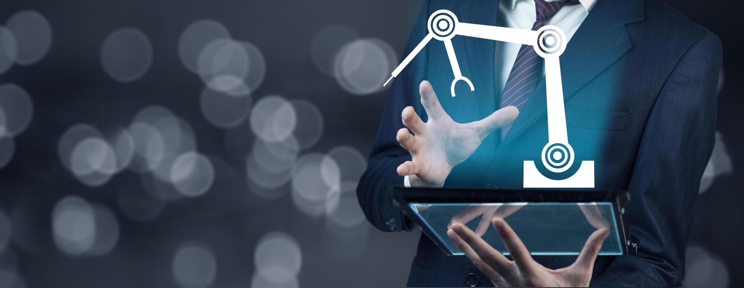 A man in a suit holding a tablet with a robot on it photo