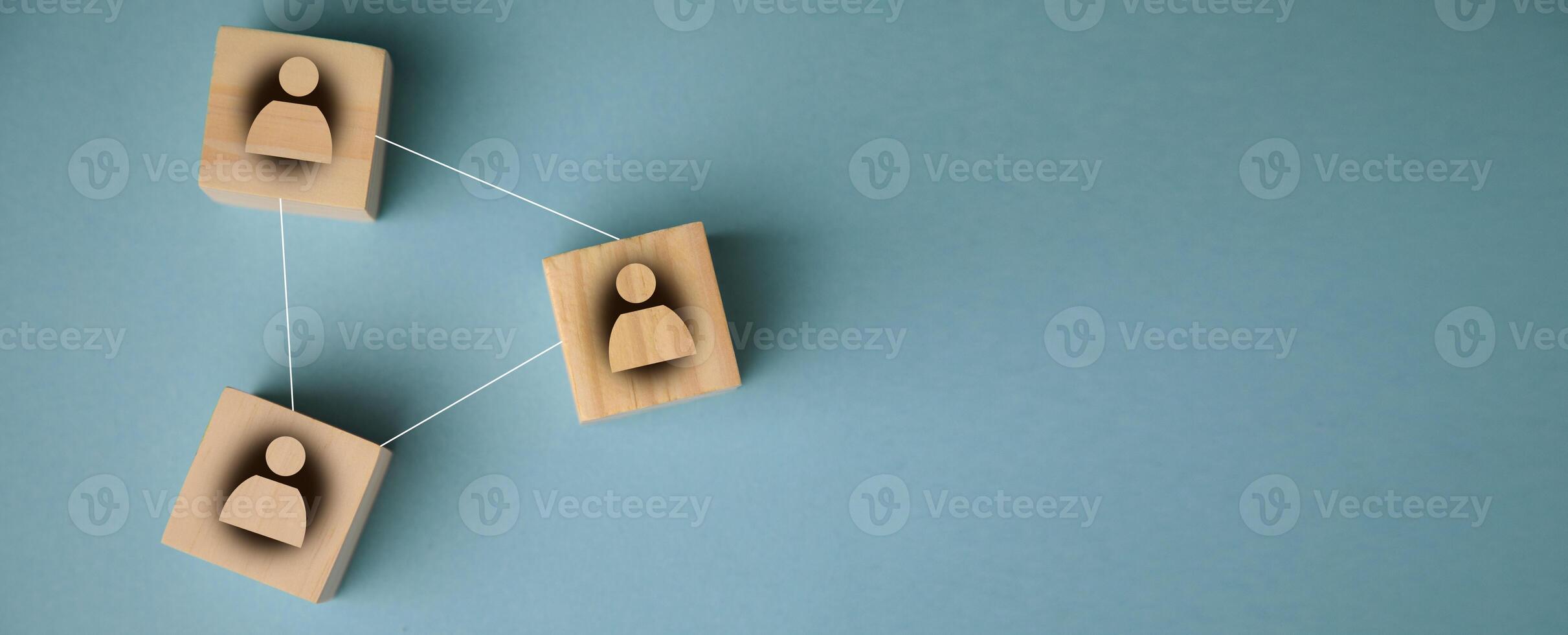 A group of people are connected by wooden blocks photo