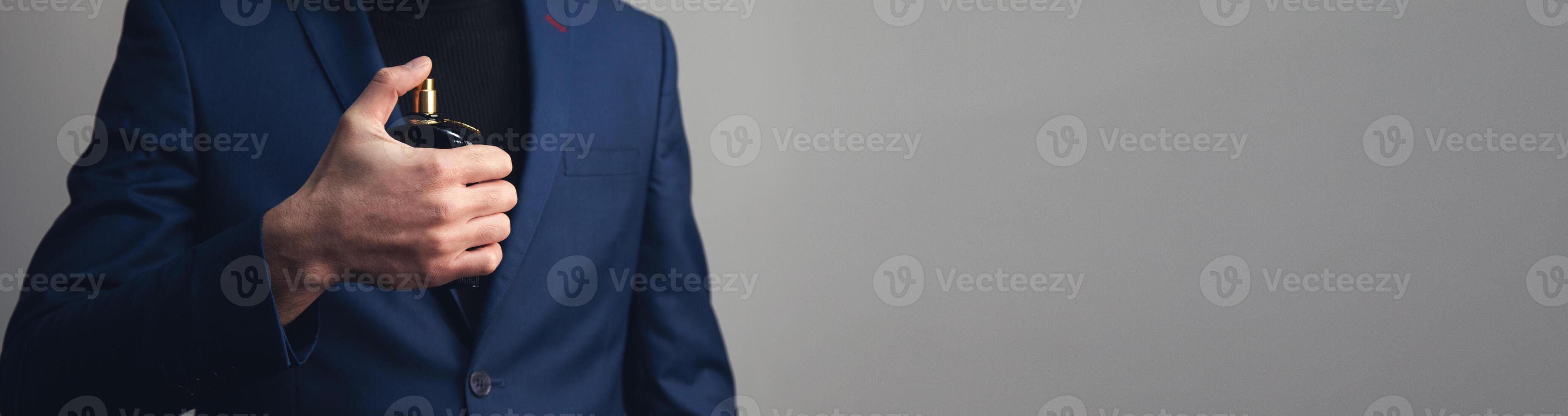 A man in a suit holding a cigarette photo