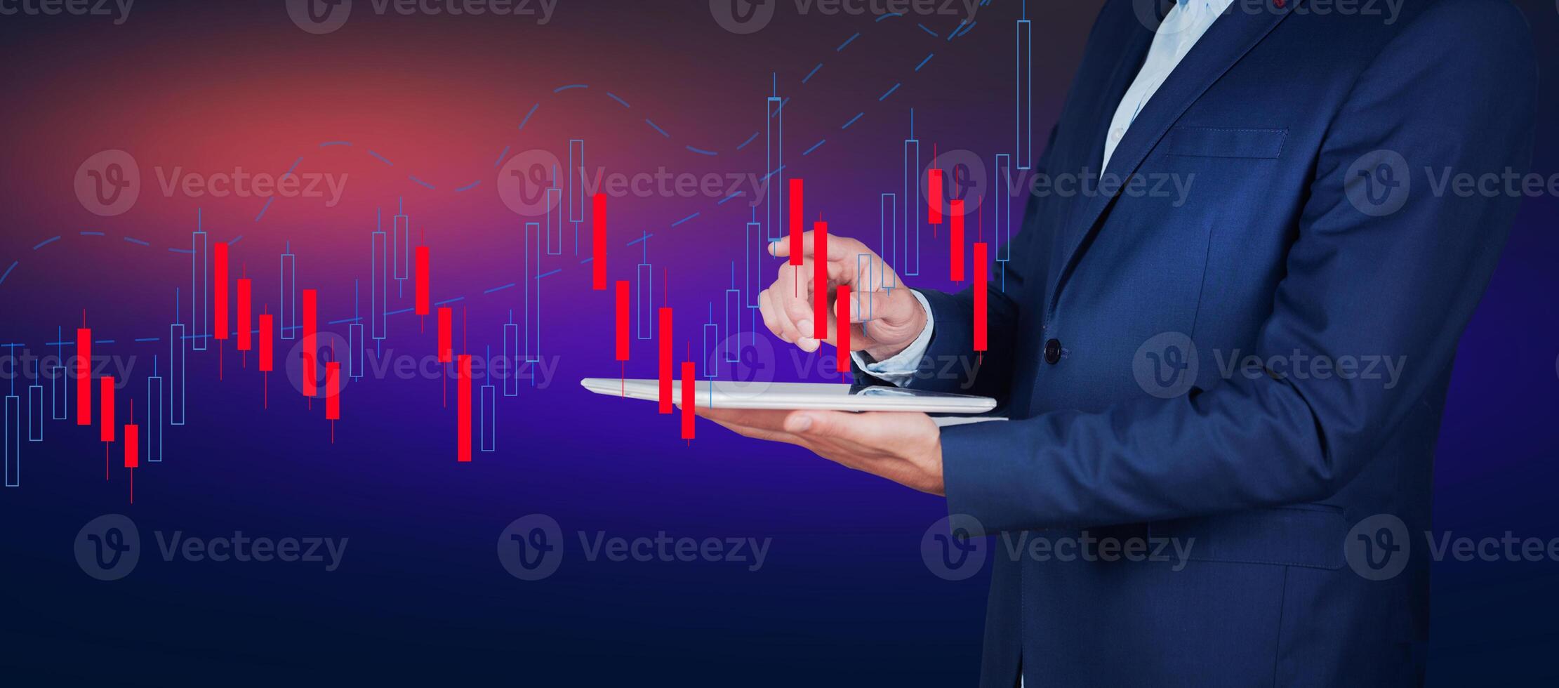 Businessman holding tablet with stock chart on background photo