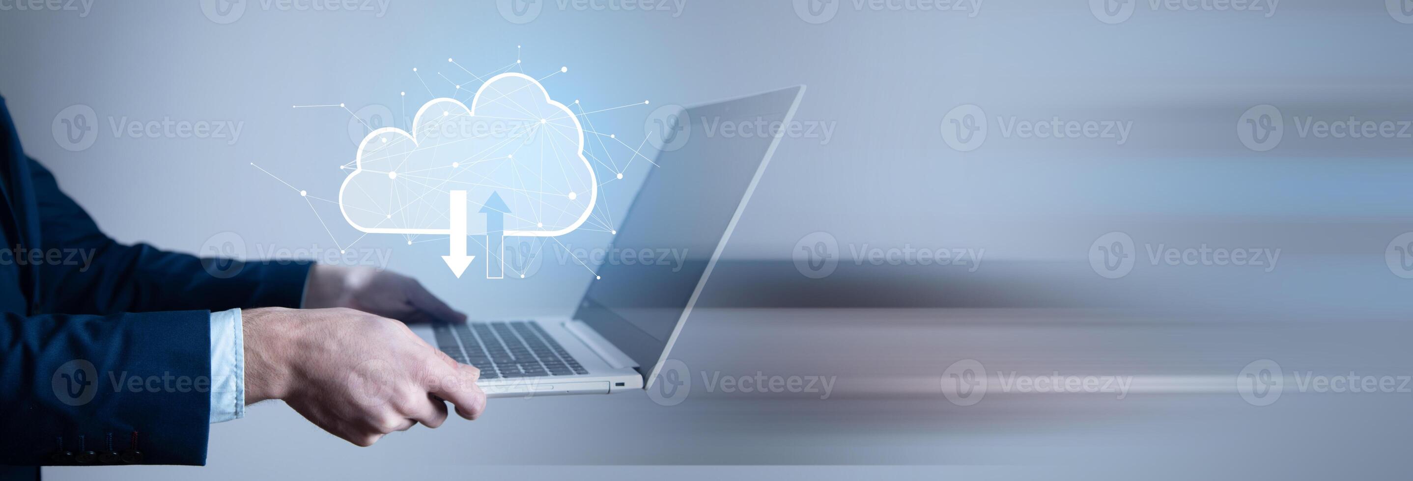 Man in suit holding laptop with cloud computing icon photo