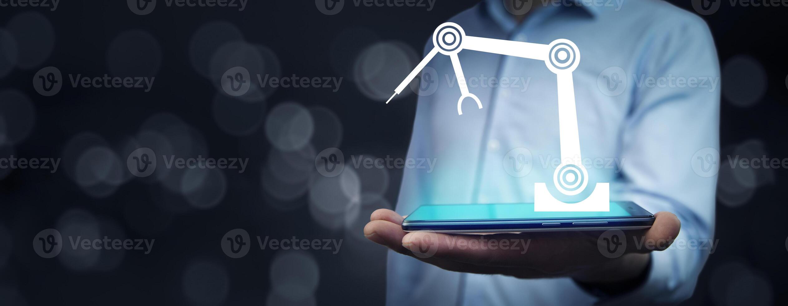 A man holding a smartphone with a robot on it photo