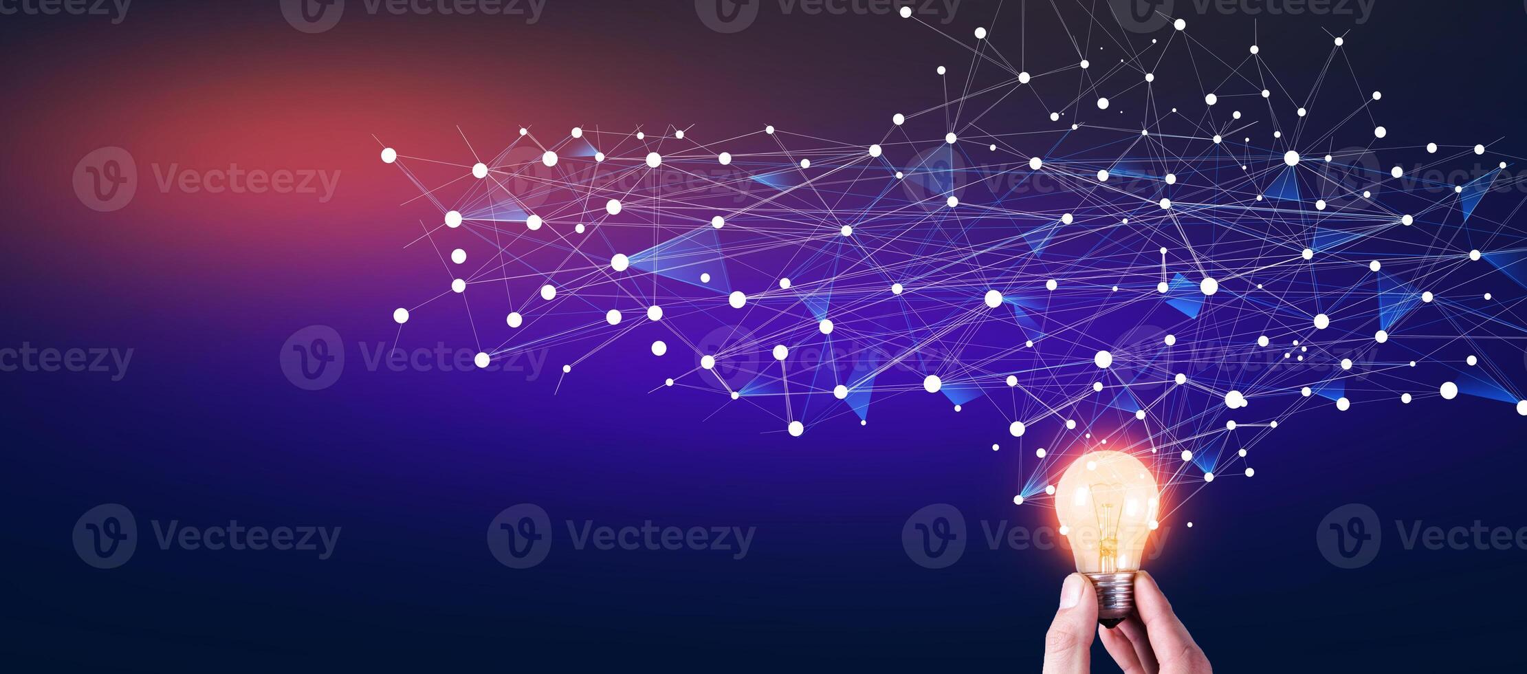 Hand holding light bulb with connected dots and network connection on dark background photo