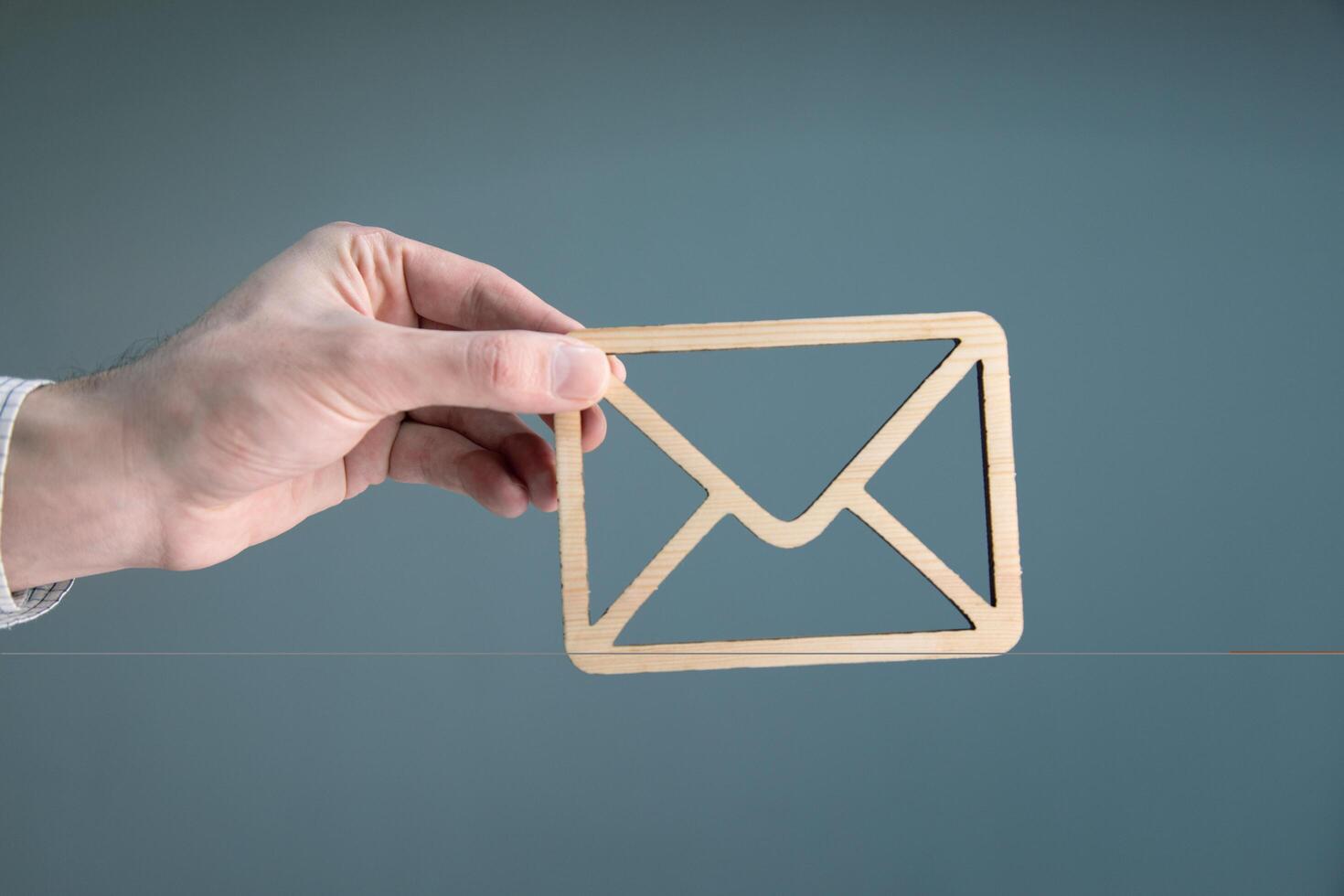 Email icon on wooden string photo