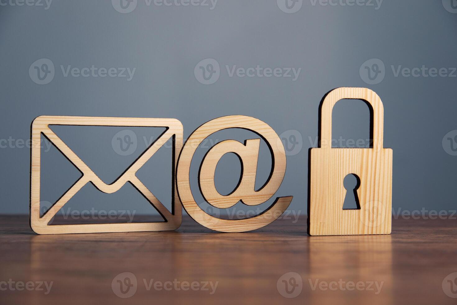 Wooden email, lock and envelope on a table photo