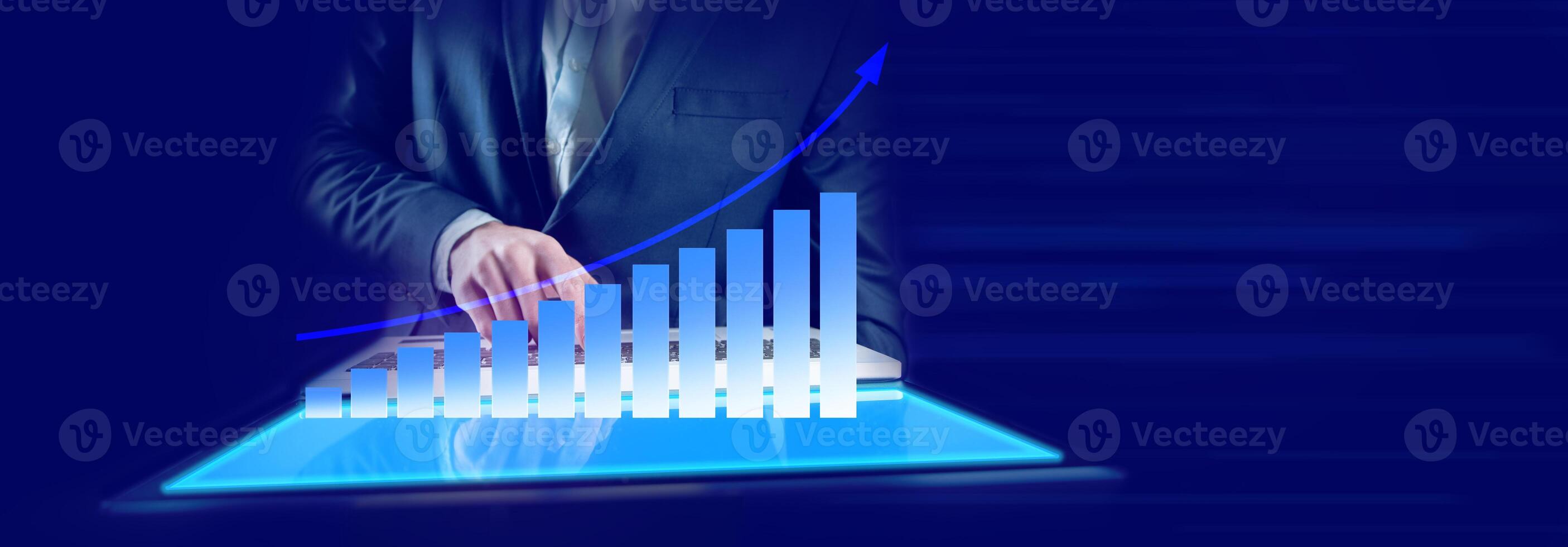 Businessman in suit holding tablet with graph on it photo