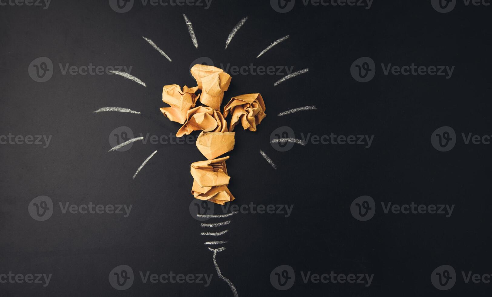 A light bulb with crumpled paper on it photo