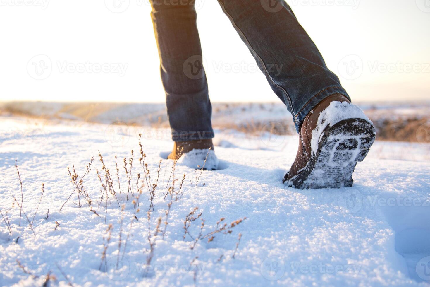 A person walking in the snow with their shoes on photo