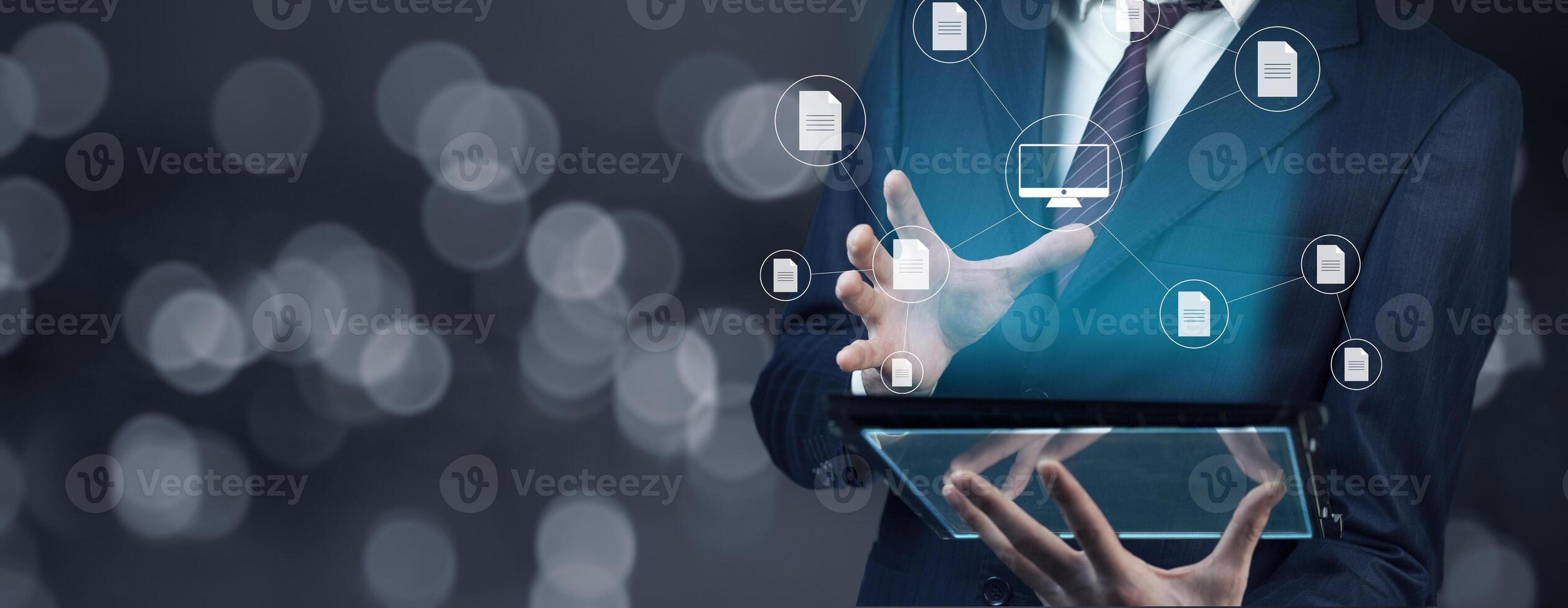 Businessman using tablet with icons on background photo