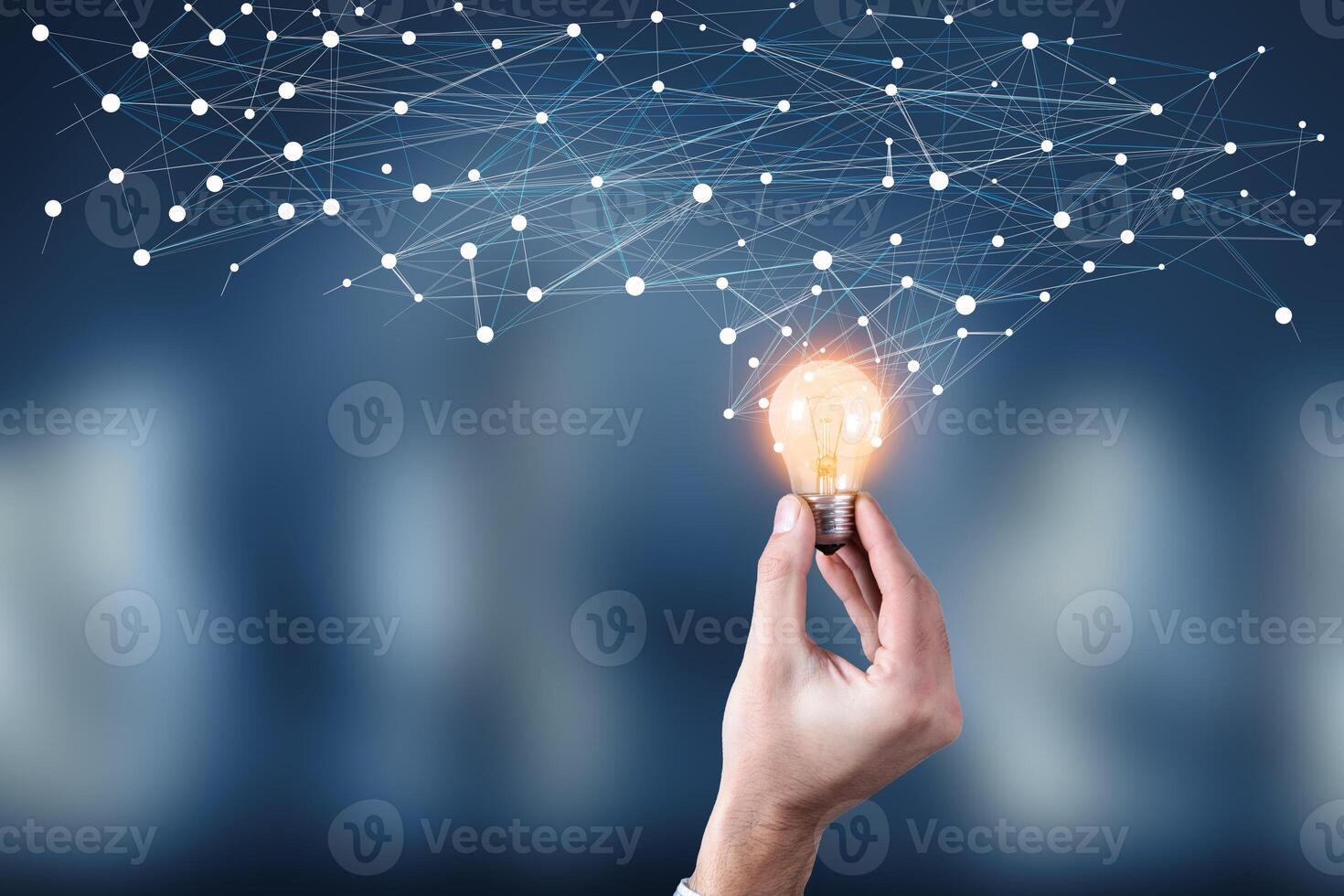 A hand holding a light bulb with a network connection photo