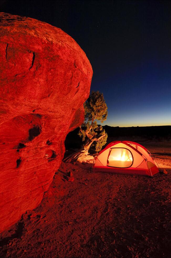 a tent is lit up at night photo
