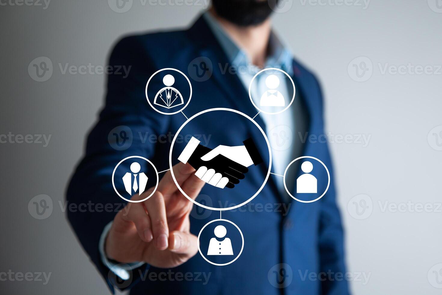 Businessman hand pointing to icons of business people photo