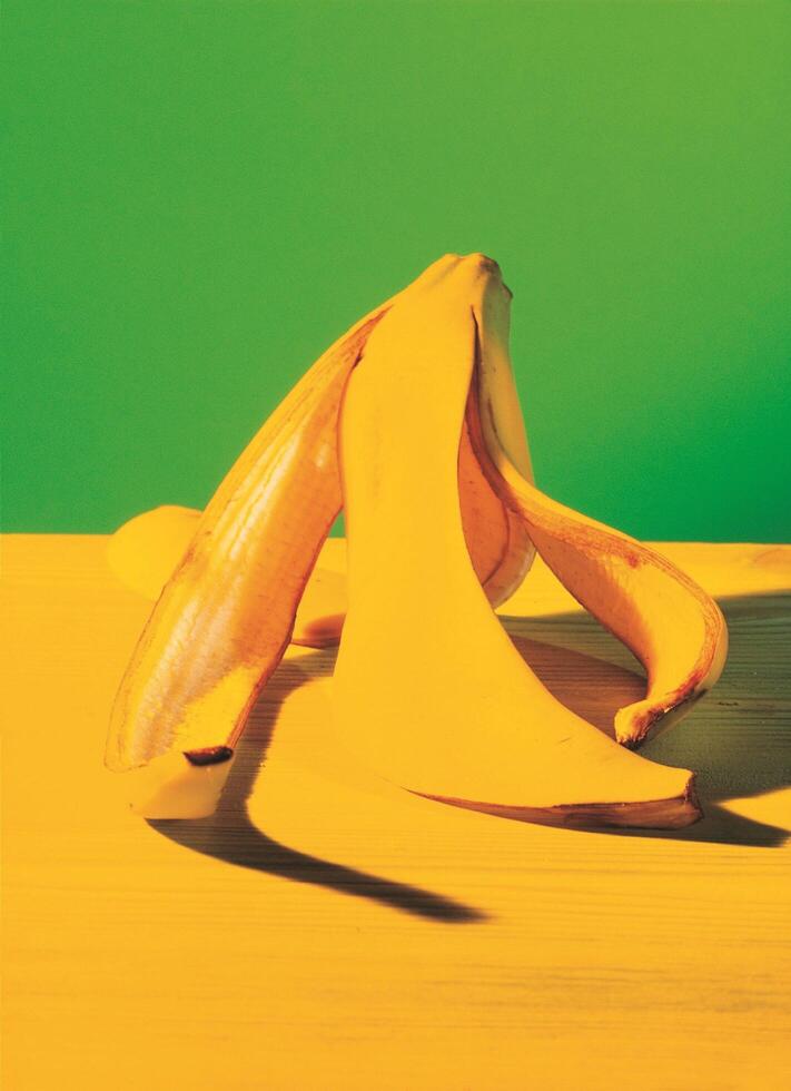 a banana on a table with a green background photo