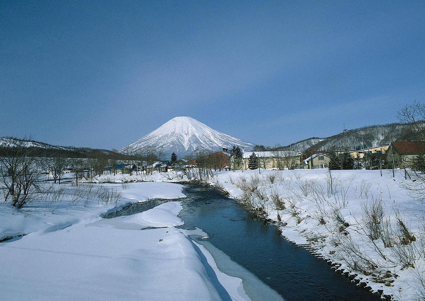 a river flowing through a snowy landscape photo