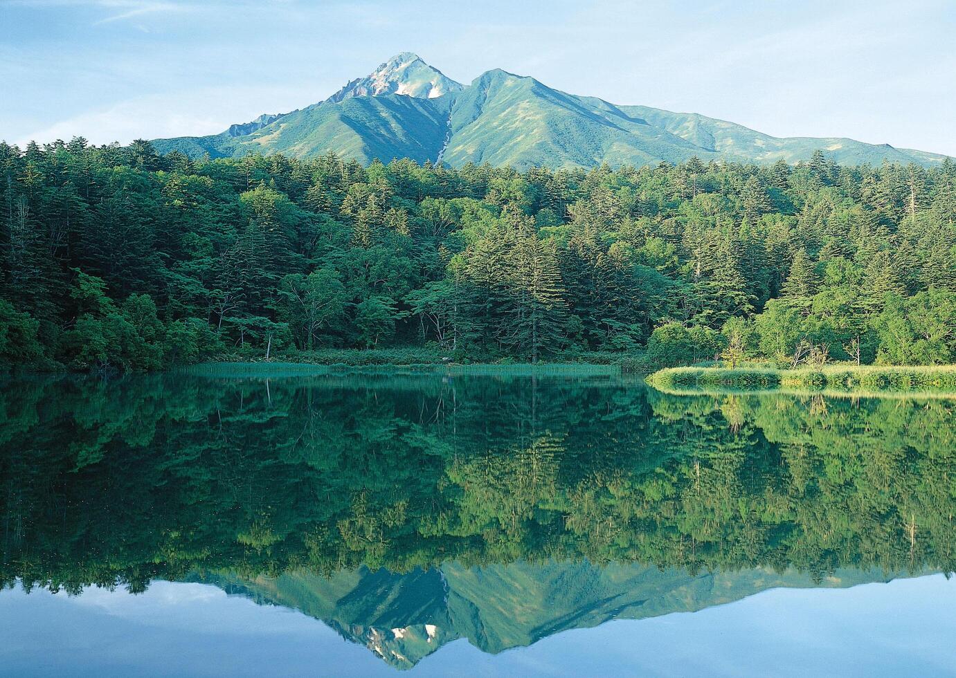 a mountain in the distance water photo