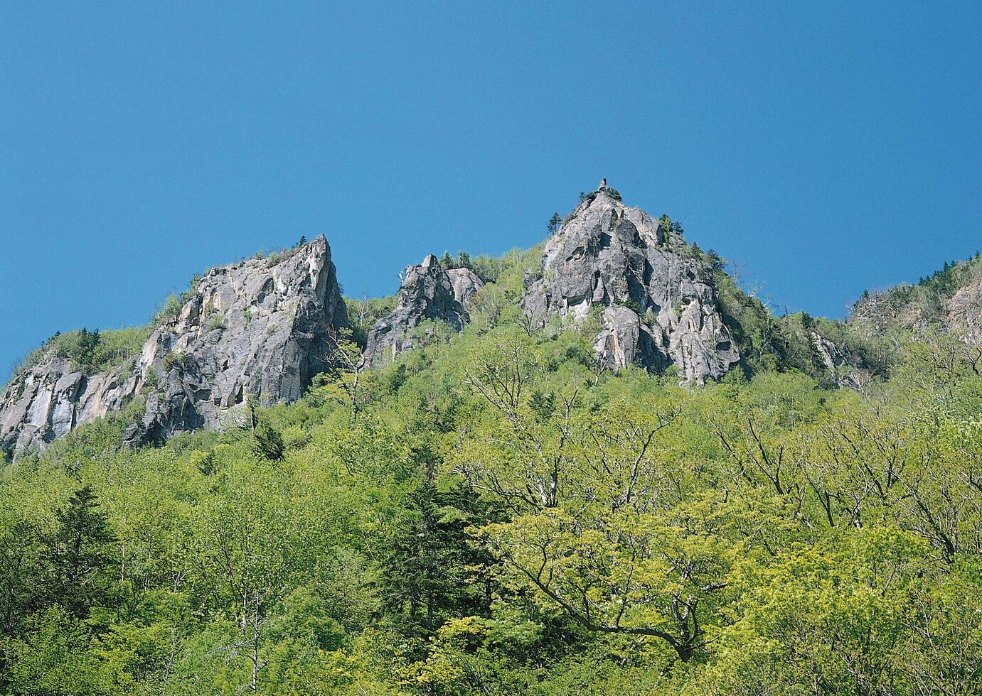 a large mountain with a clock tower on top photo