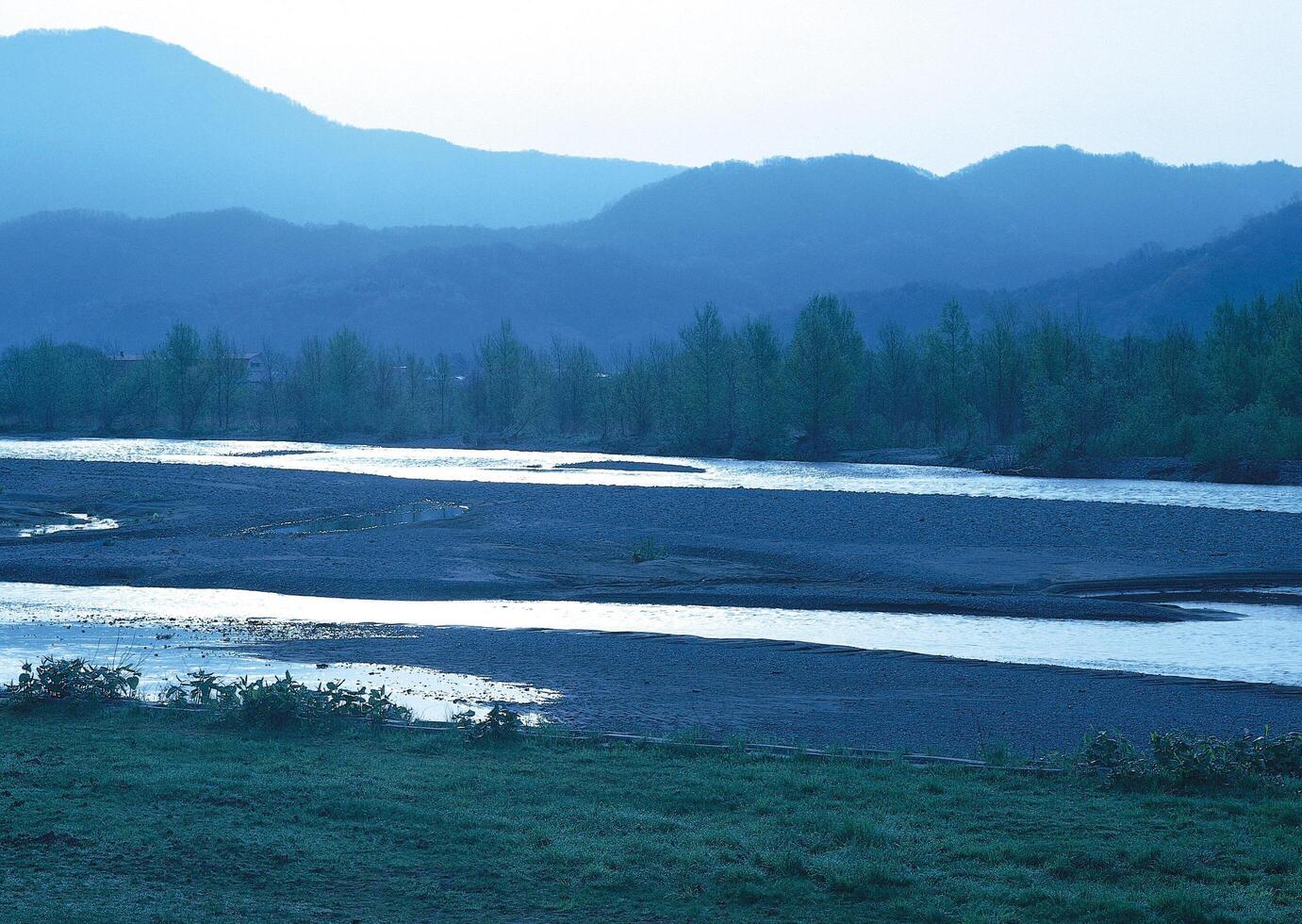 a river with a mountain in the background. photo