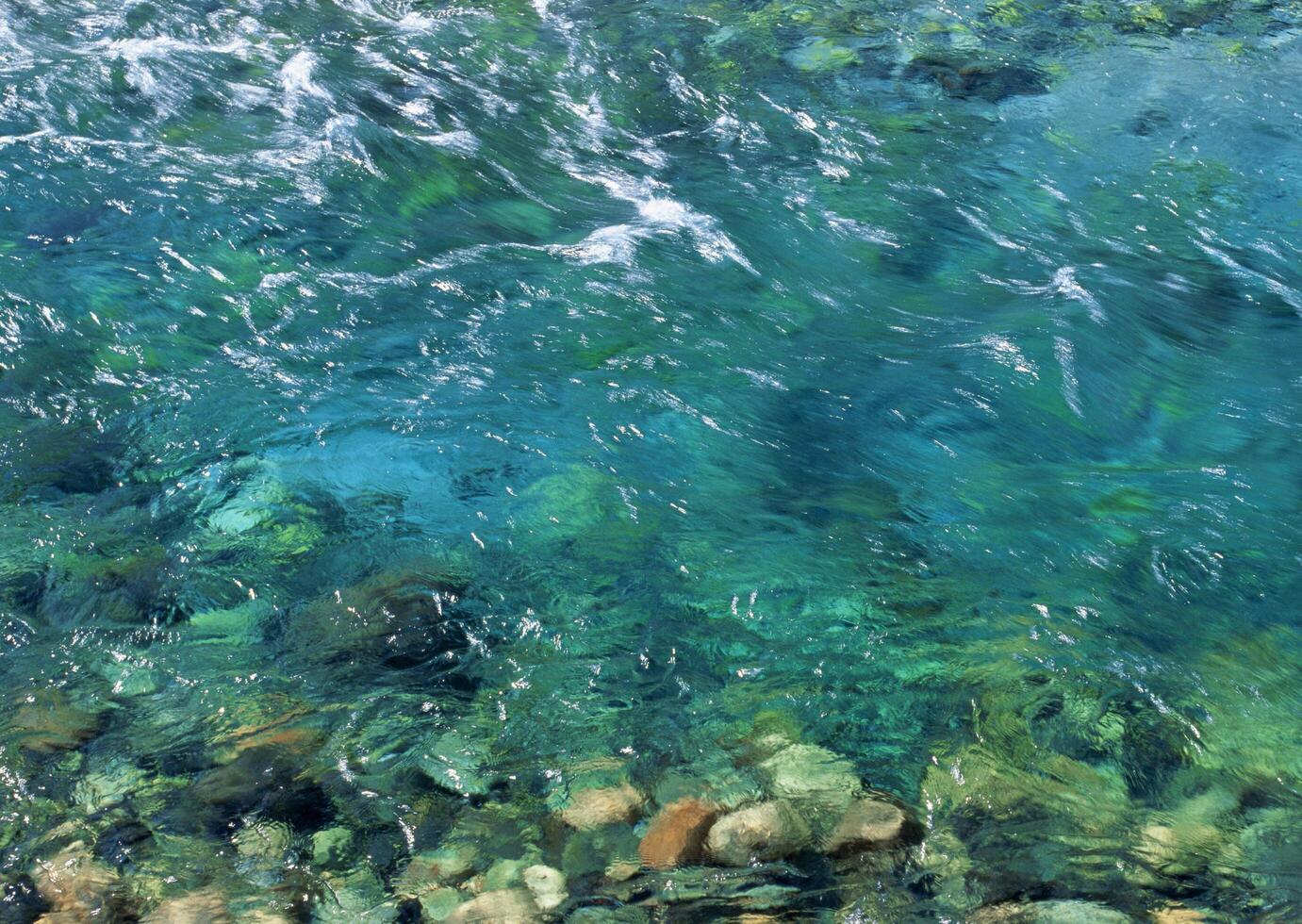 a view of the water in a river with rocks and rocks photo