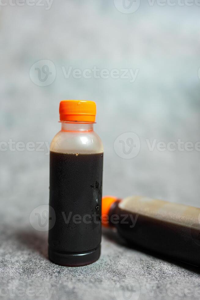 Bottle of tasty cold brew on grey background photo