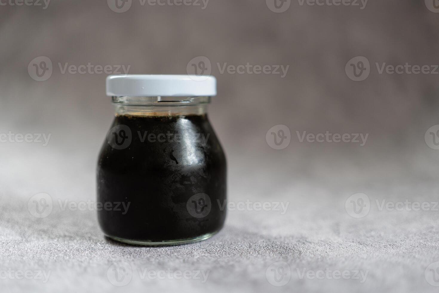 Take away mini bottle with black coffee photo