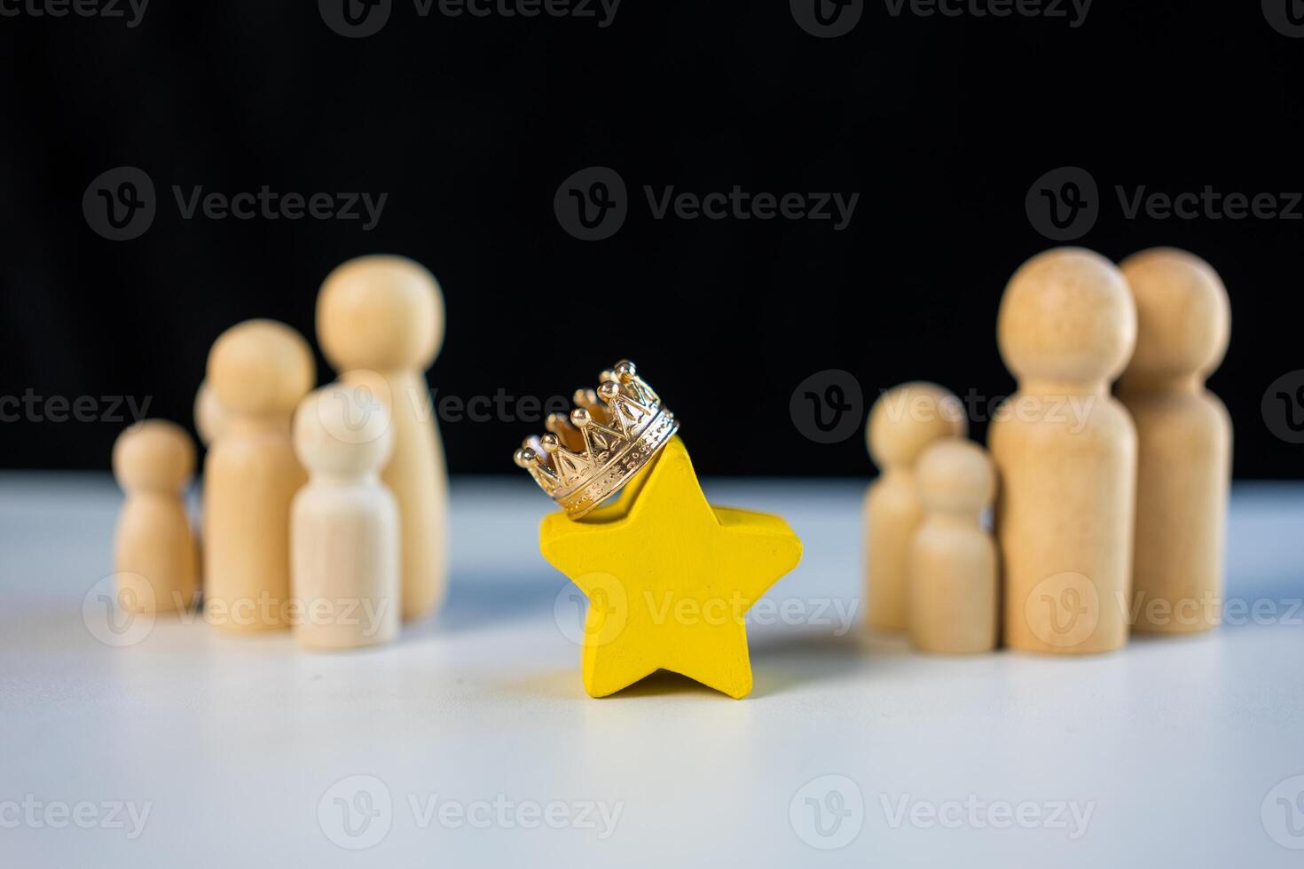 Wood star with crown and standing in the center of peg doll. Talent management, Recruitment employee photo