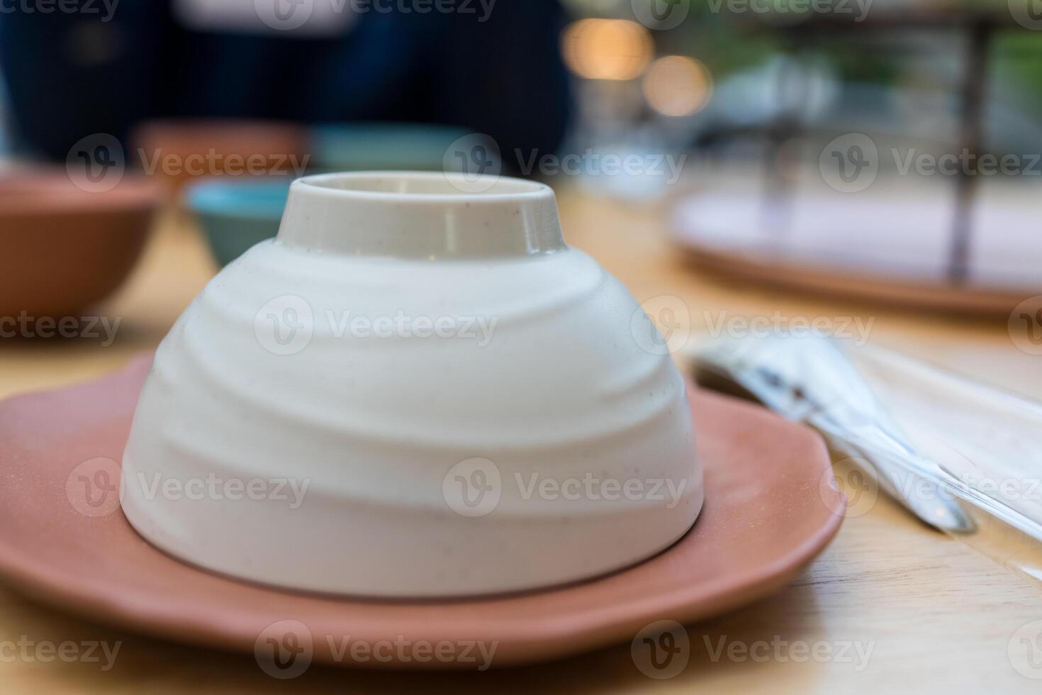 Empty upside down ceramic bowl ready to use in restaurant photo