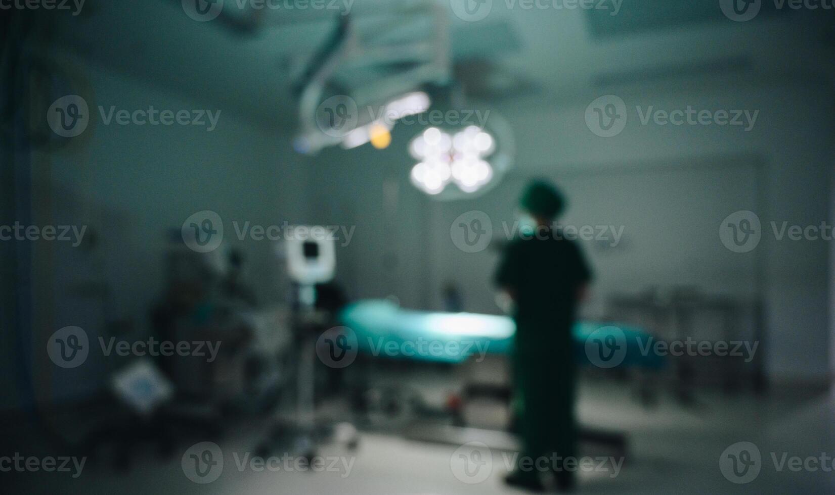 Blurred image of healthcare worker standing in operating room or surgical room in hospital. photo