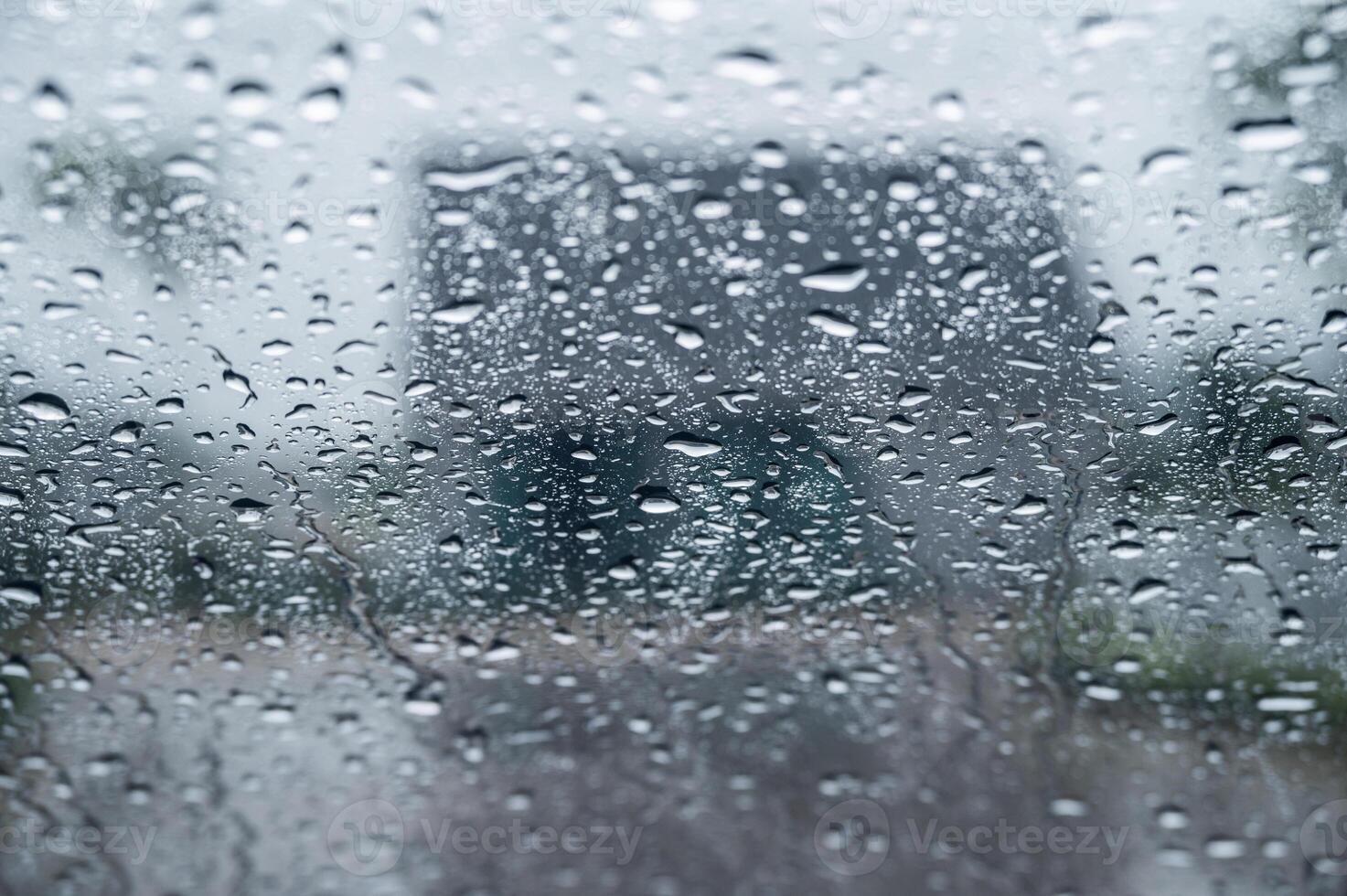 Dew drop on the car glass window during raining. Dew is the moisture that forms as a result of condensation. photo
