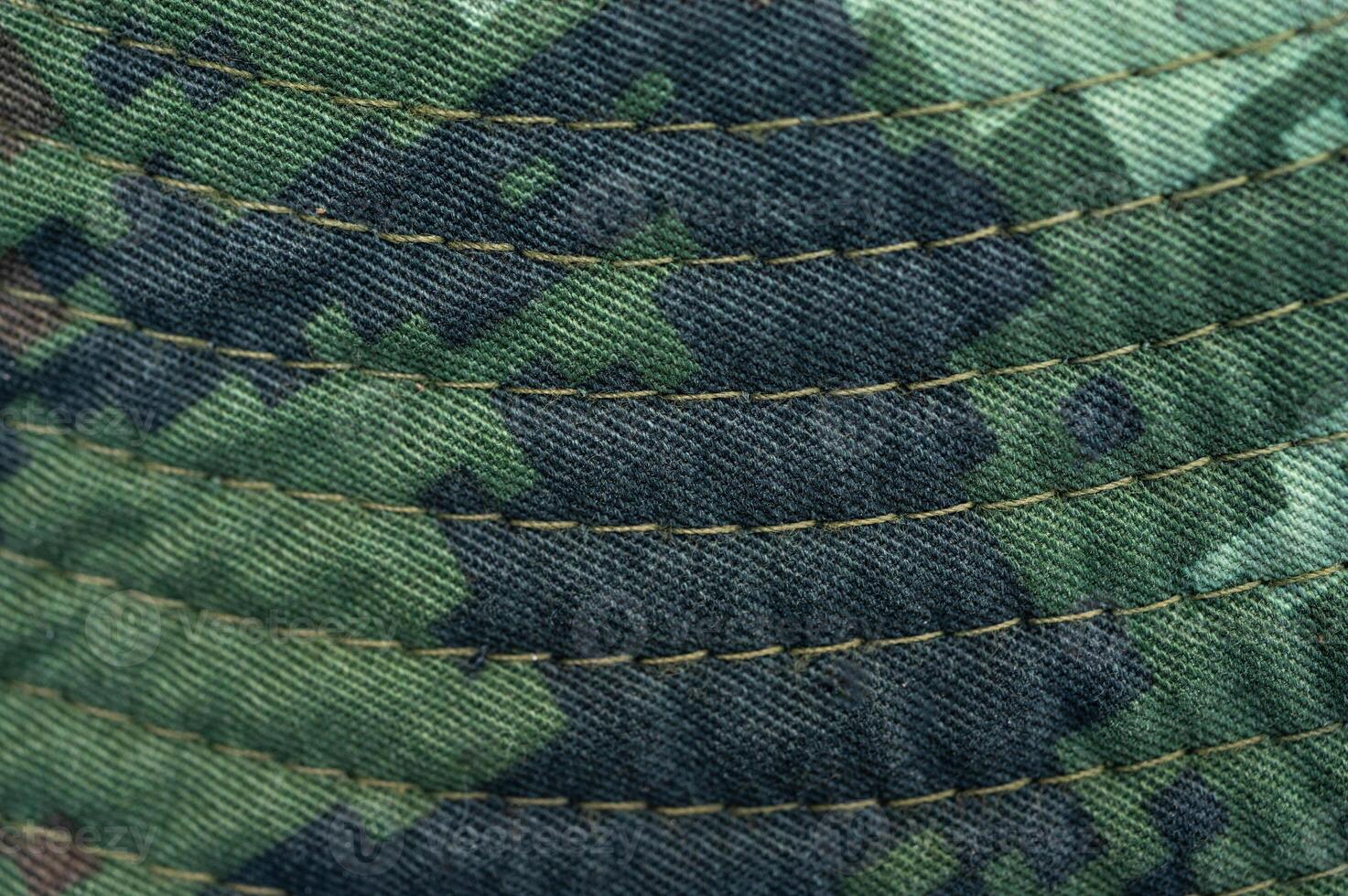 Close up of textured camouflage military uniform of soldier. photo