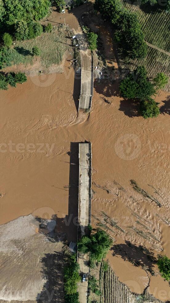 Aerial view of small bridge in Mae Yao district of Chiang Rai province collapsed after Kok river flooded. photo