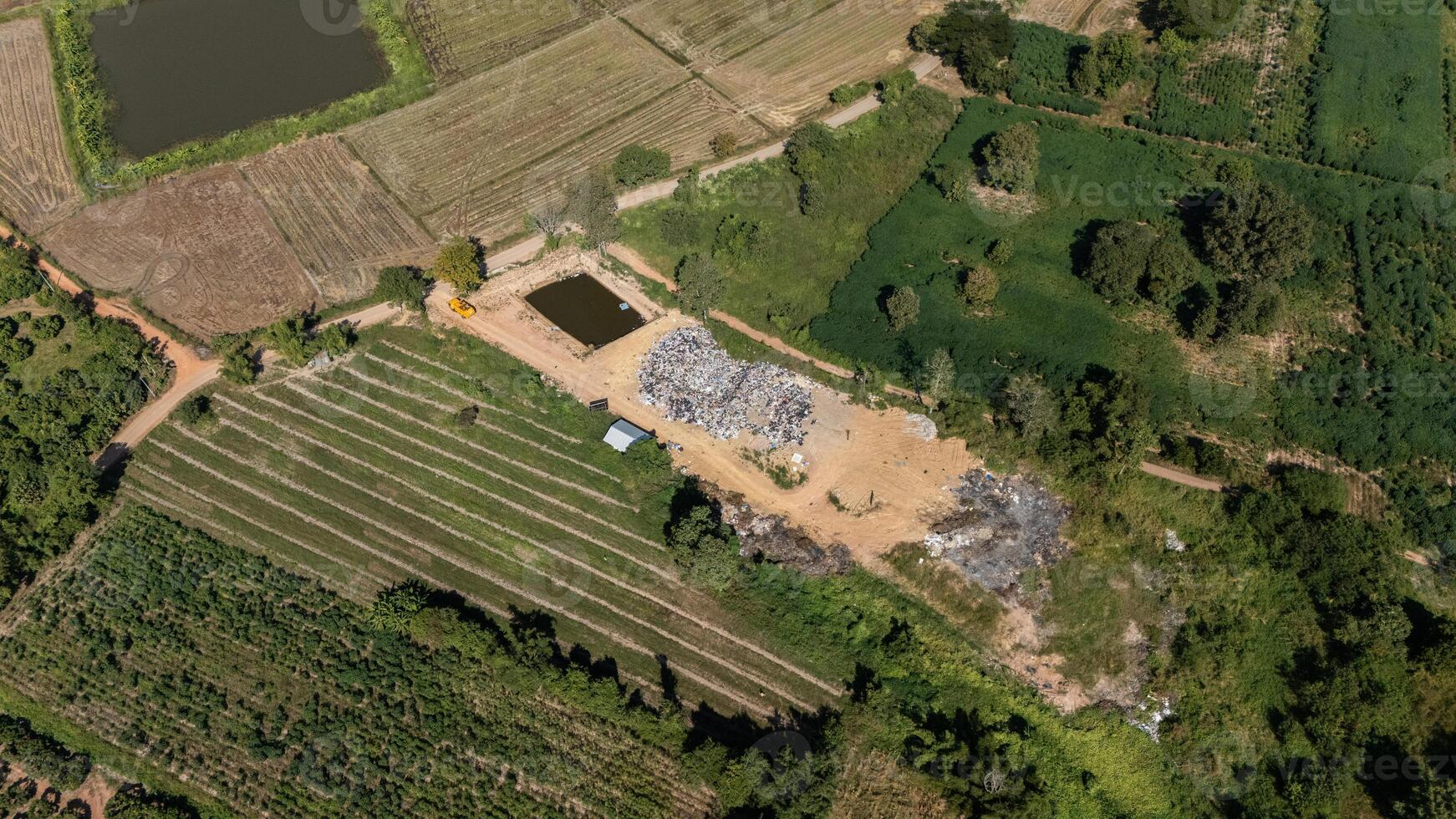 High angle view of the garbage field in rural Thailand. It provides a specific place for the disposal of garbage. photo