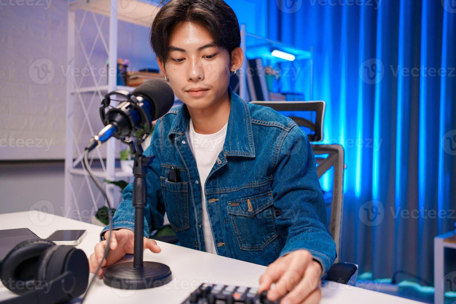 Man Adjusting Microphone for Podcast Recording photo