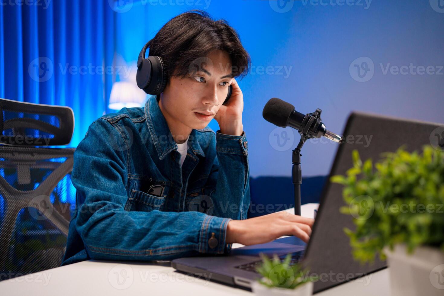 Podcaster Working on Laptop During Session photo