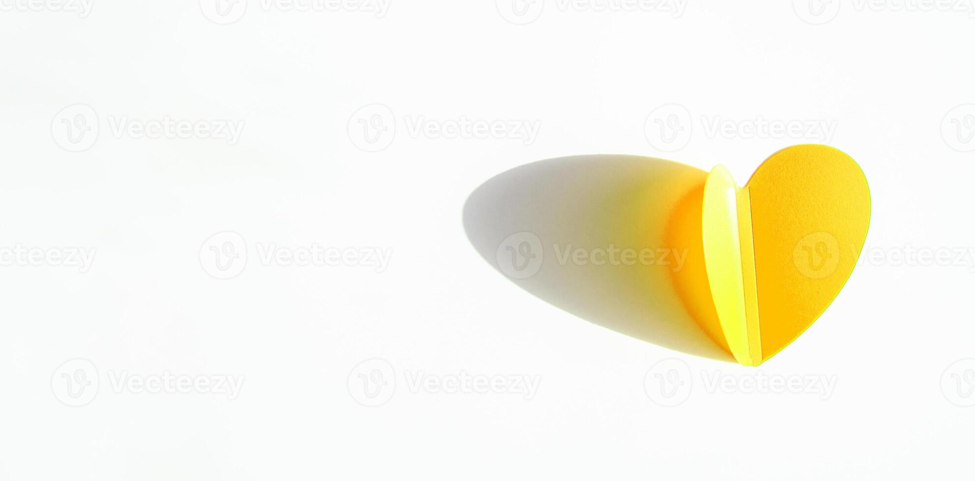 Banner with gold heart shaped paper decoration on white background. Flat plan, top view, space for text on the left side photo