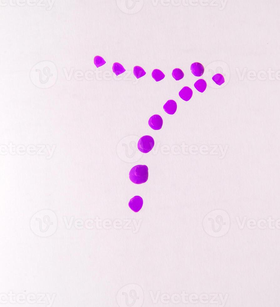 Shiny drops of lilac nail polish on a white background, beauty concept, vertical photo