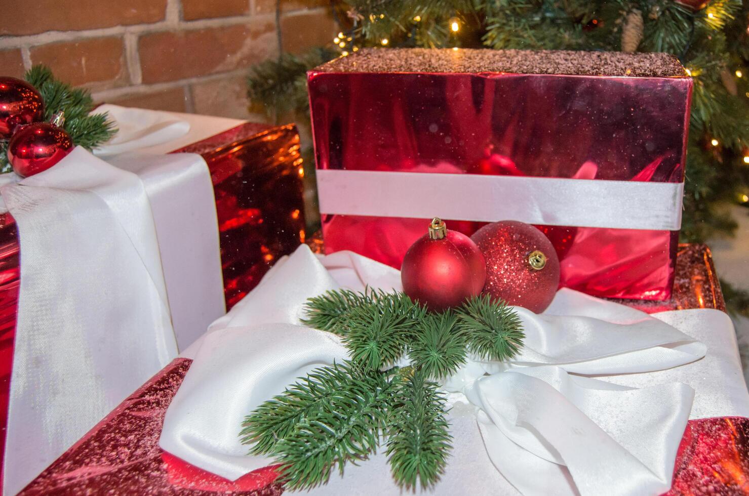 Christmas gifts, Christmas balls, fir branches on the background of gift boxes in sparkling foil photo