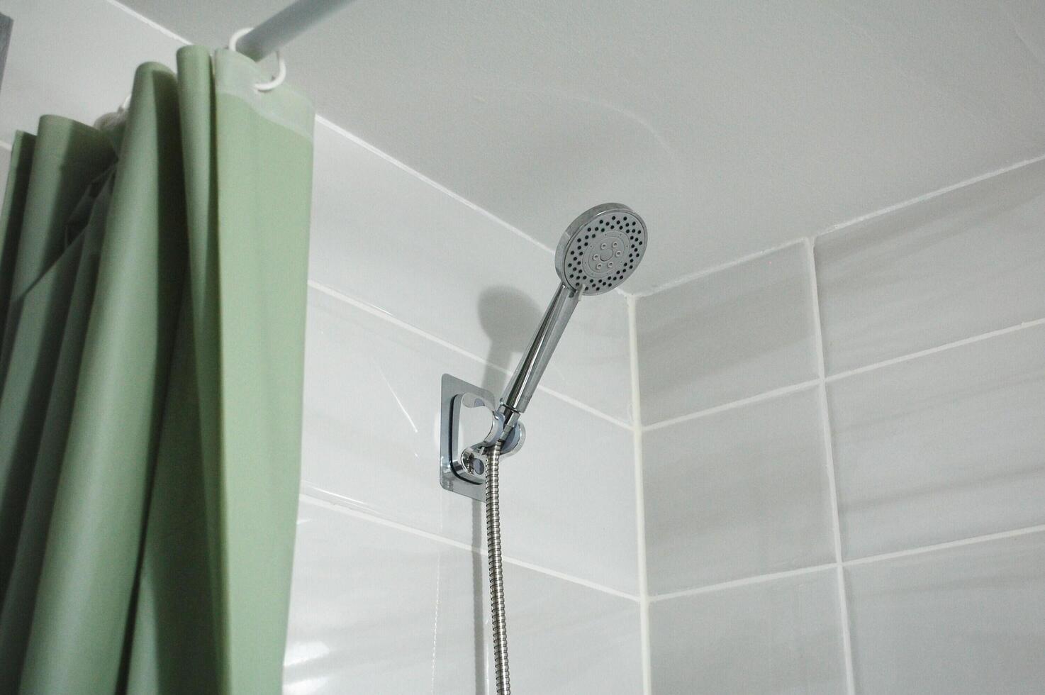 Shower head in the wall with grey tile photo