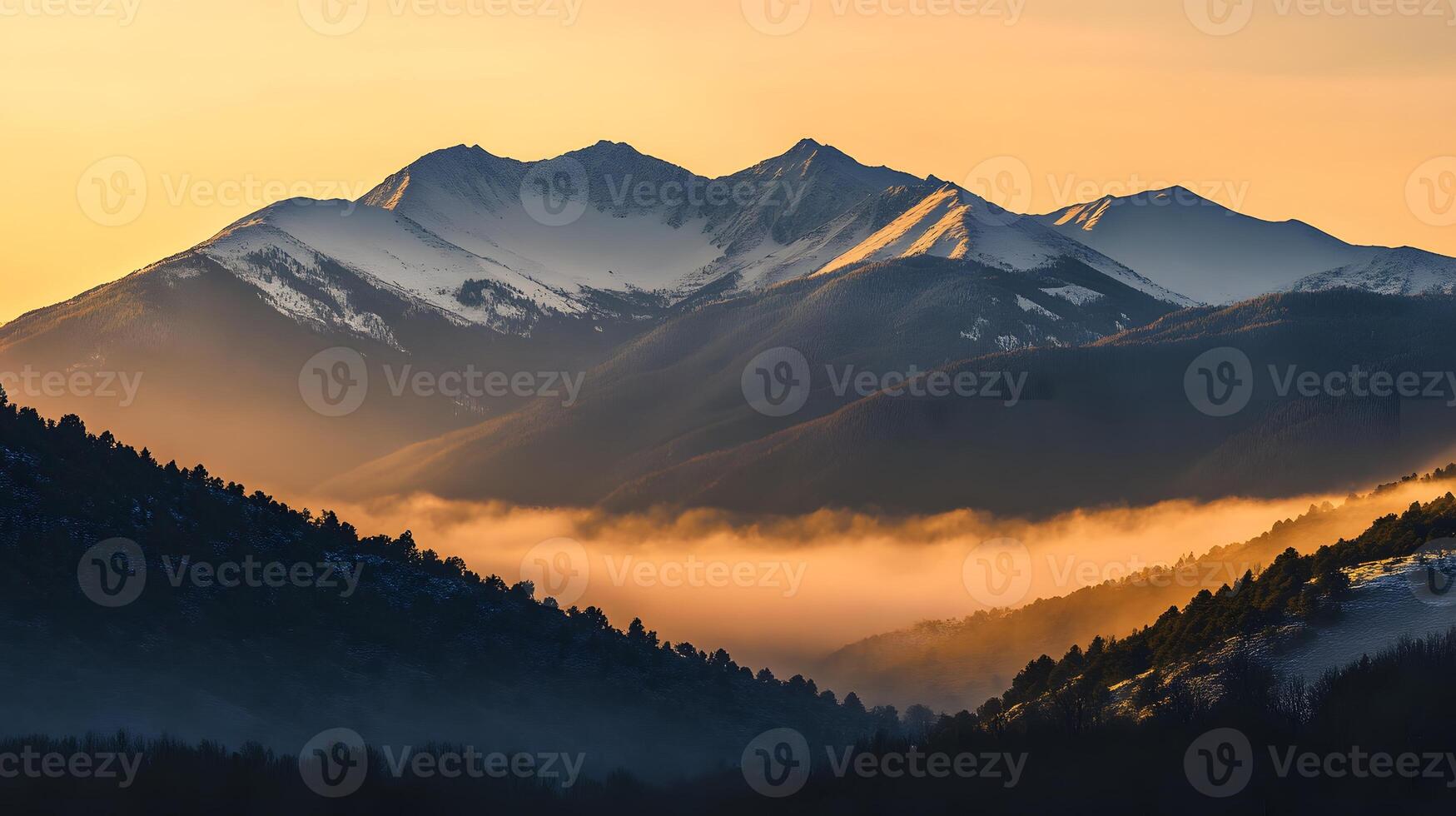 A mountain range with fog and snow photo