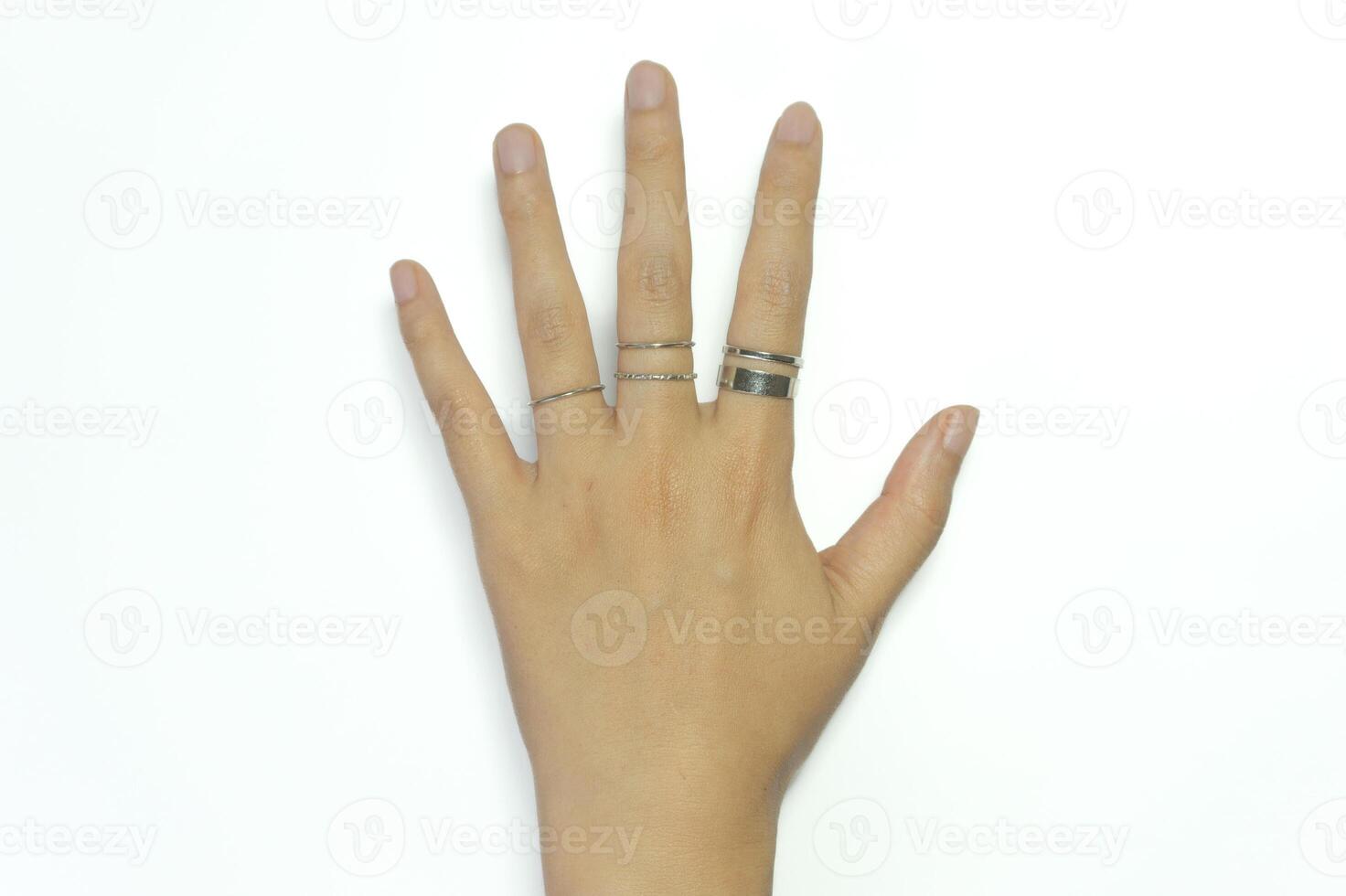 Young Asian woman's hand with a ring on her finger isolated on white background. photo