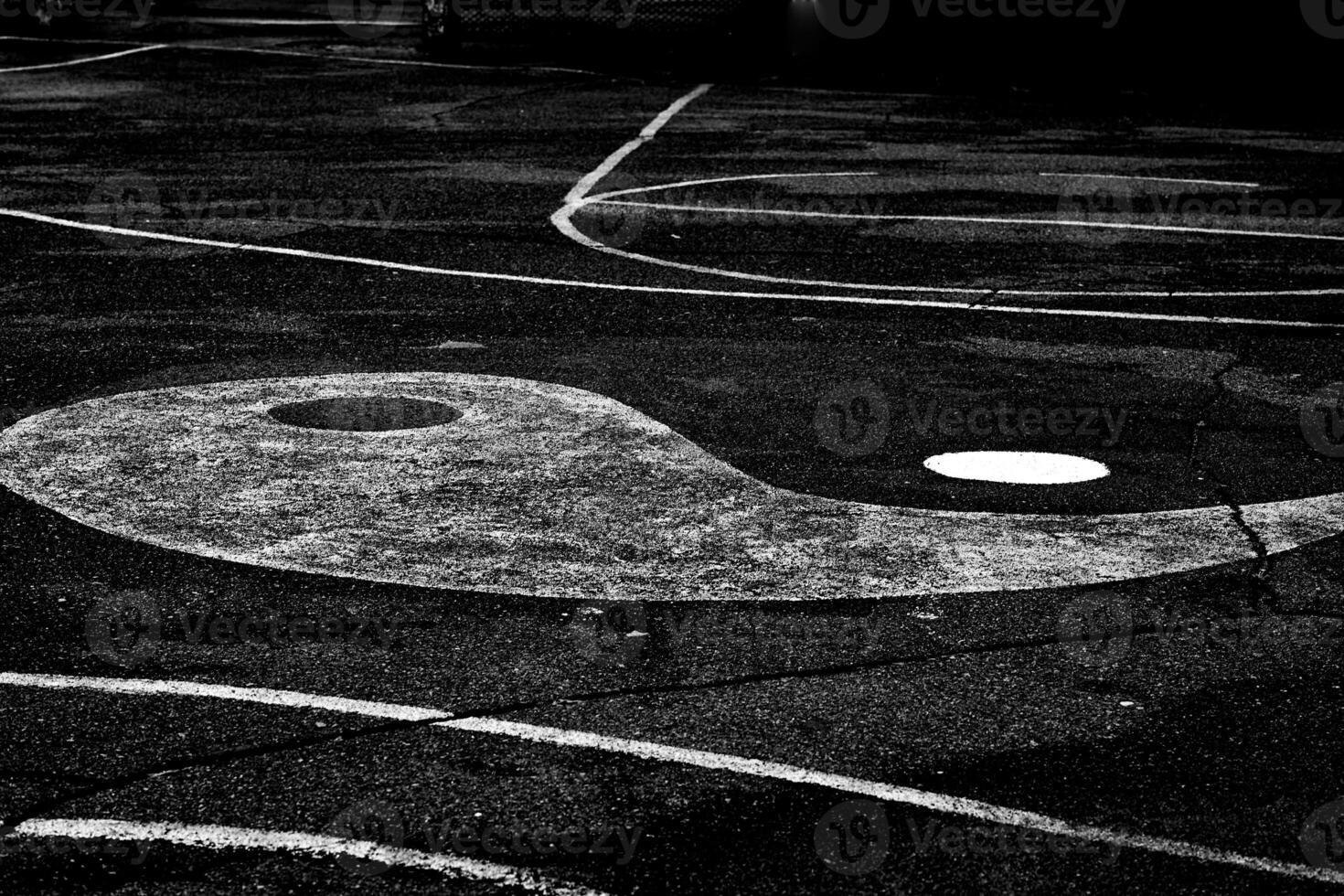 Orient Yin Yang sign on the asphalt of a sports ground photo